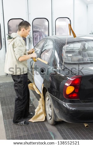 MOSCOW - SEP 21: Repairman prepare the car for painting on body shop Avtostandart on September 21, 2012 in Moscow, Russia.