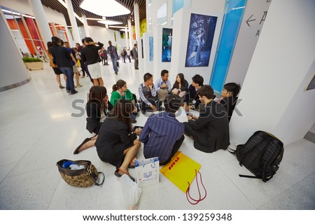 MOSCOW - AUG 20: Group of participants of Global Youth to Business forum sits on floor in lobby of congress-hall of Moscow School of Management SKOLKOVO, August 20, 2012, Moscow, Russia.