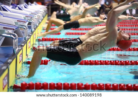 MOSCOW - APR 20: Men at the start of jumping into the water in the pool at the Championship of Russia on swimming in Olympic Sports complex, on April 20, 2012 in Moscow, Russia