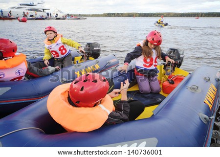 MOSCOW - SEP 29: Children in inflatable boats at Powerboat Race Show 2012 in yacht club Gals, Sep 29, 2012 Moscow, Russia. Event is organized by Russian Racing Group .