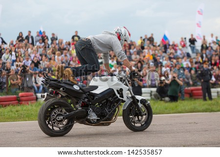 MOSCOW - AUG 25: Biker climbed feet on a motorcycle on Festival of art and film stunt Prometheus in Tushino on August 25, 2012 in Moscow, Russia. The festival was organized in 1998.