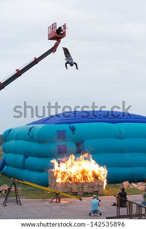 MOSCOW - AUG 25: Man jumping from a height into the burning box on Festival of art and film stunt Prometheus in Tushino on August 25, 2012 in Moscow, Russia. The festival was organized in 1998.