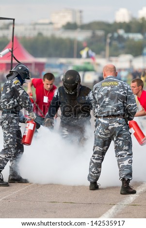 MOSCOW - AUG 25: Rescue workers extinguish a stunt man after ignition on Festival of art and film stunt Prometheus in Tushino on August 25, 2012 in Moscow, Russia. The festival was organized in 1998.