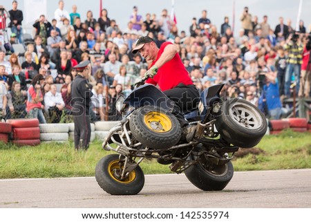 MOSCOW - AUG 25: Man stunt shows on a quad bike on Festival of art and film stunt Prometheus in Tushino on August 25, 2012 in Moscow, Russia. The festival was organized in 1998.