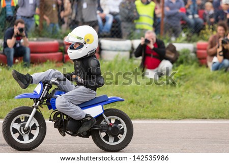 MOSCOW - AUG 25: Kid on motorcycle stunt shows on Festival of art and film stunt Prometheus in Tushino on August 25, 2012 in Moscow, Russia. The festival was organized in 1998.