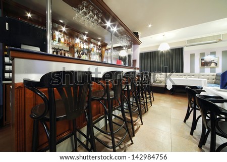 MOSCOW - NOVEMBER 9: Black chairs stand at bar in restaurant of Neva cinema, on November 9, 2012 in Moscow, Russia. Neva - is former popular restaurant White Guard.