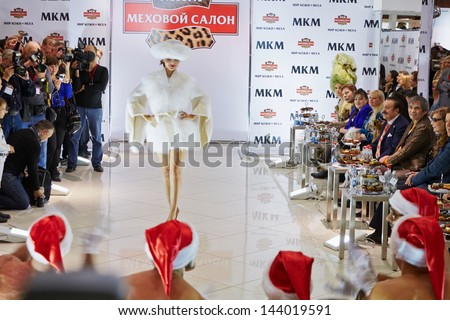 MOSCOW - OCT 22: Model performs fur dress from new collection to guests and press at salon World of Leather and Fur during celebration Phoney New Year, October 22, 2012, Moscow, Russia.