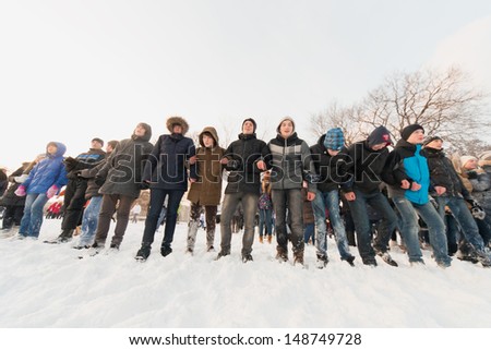 MOSCOW - DEC 9: Several people standing in a row in the Central Park of Culture and Rest named after Maxim Gorky December 9, 2012 in Moscow, Russia. The park was established in 1928.