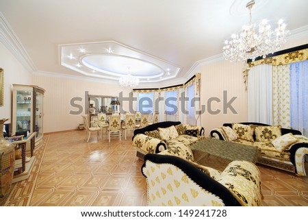Living and dining room with luxury furniture in classic style.