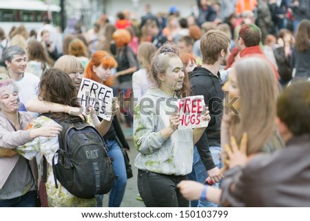 MOSCOW - MAY 26: People in the paint and with signs Free Hugs on the festival of Indian colors Holi on May 26, 2013, Moscow, Russia. The festival took place near the Izmaylovo Kremlin
