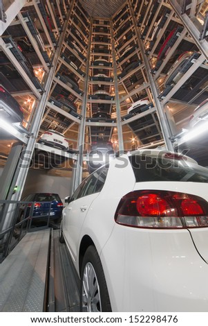 MOSCOW - JAN 11: Bottom view in construction for storage cars with Volkswagen Golf foreground in Varshavka Center at night on January 11, 2013, Moscow, Russia. The tower was built in 2009