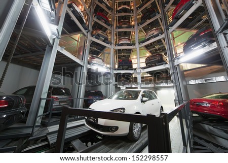 Moscow - Jan 11: The Volkswagen Golf On Parking Lot With A Multi-Story Automated Car Parking System In Tower In Volkswagen Center Varshavka At Night On January 11, 2013, Moscow, Russia