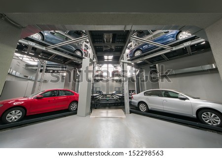 MOSCOW - JAN 11: Cars and the elevator in the tower for the presentation and storage of cars in the Volkswagen Varshavka Center on January 11, 2013, Moscow, Russia. The tower was built in 2009