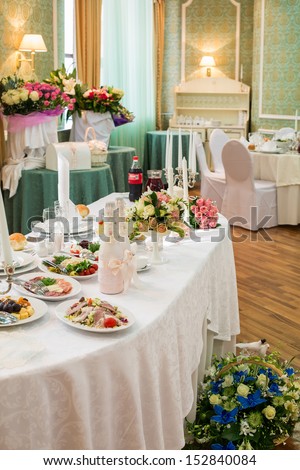 Table with food and drink in a restaurant decorated for a wedding celebration