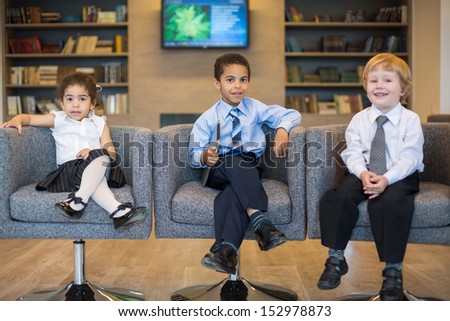 Three children in the clothing business in a business center, focus on the boy in the center