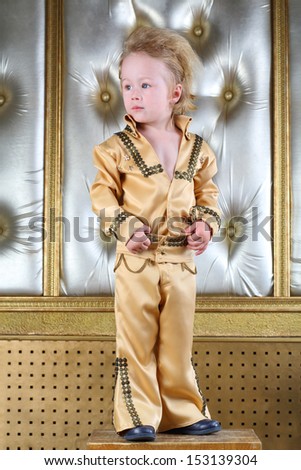 Portrait of a little boy in pop retro suit