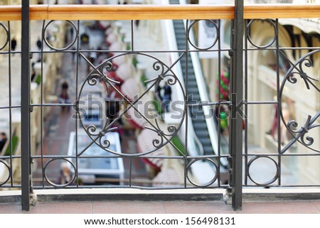 Beautiful wrought iron railings on balcony in large shopping mall.