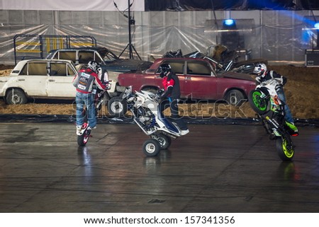 MOSCOW - MAR 23: Three stuntmen rides on the rear wheel of bikes on Show Monster Mania in Olimpiyskiy in March 23, 2013 in Moscow, Russia.