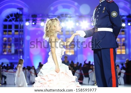MOSCOW - FEB 22: Beautiful little girl gives her hand to the gentleman, on February 22, 2013 in Moscow, Russia.