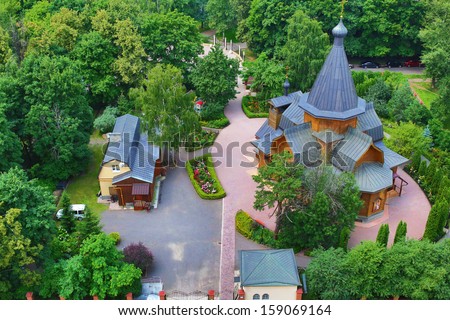 View at wooden Church of St. Nicholas in the Straw Gatehouse and church yard from high angle