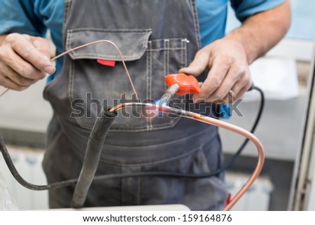 Worker the air conditioner pipe welds oxyfuel gas welding
