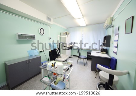 Contemporary empty dental office with dental chair and equipment