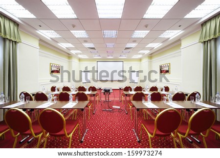 Tables, Rows Of Red Chairs And Projection In Room For Business Meetings.