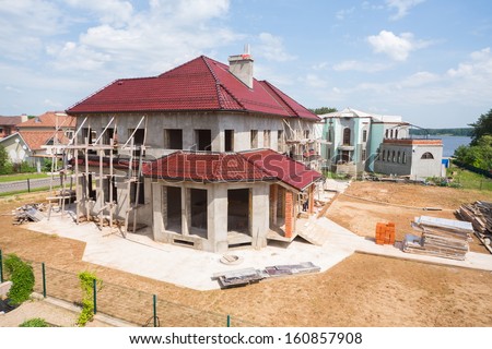 Two Storey Cottage Under Construction With A Sand In Front
