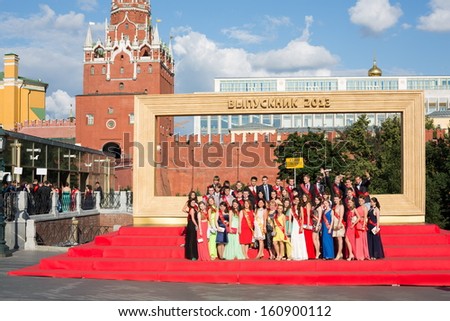 MOSCOW - JUN 23: Graduates are photographed in front of big frame on Sapozhkovaya Square near the Kremlin on June 23, 2013 in Moscow, Russia.