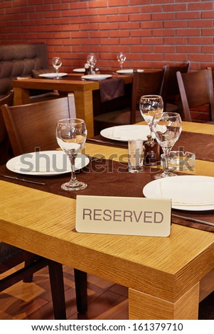 Served table with sign Reserved in restaurant