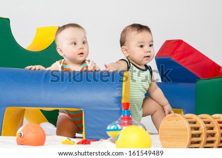 Two babies with toys in the gaming complex