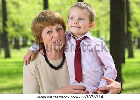 Grandmother with her grandson embracing in the park on a sunny day