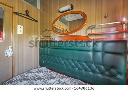 Interior compartment on the train with a mirror and a sofa