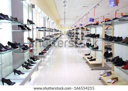 SAMARA, RUSSIA - JULY 7: A lot of women shoes on a glass shelf in a long hall of a shoe store with inscriptions Sale and indicating shoe size in shopping complex Kosmoport, July 7, Samara