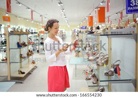 SAMARA, RUSSIA - JULY 7:  A beautiful young woman chooses shoes in one of the shops at the complex Kosmoport, July 7, Samara. Complex includes more than one hundred boutiques and shops