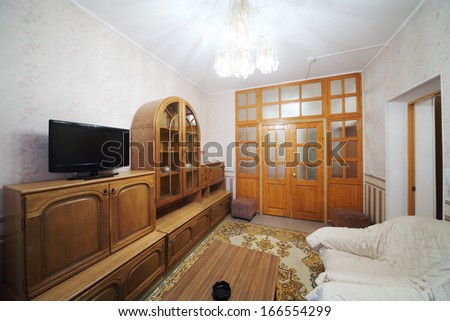 Small living room with a sofa, a cabinet and a carpet on the floor