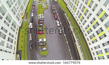 Cars at parking at wet day in residential complex. View from unmanned quadrocopter.