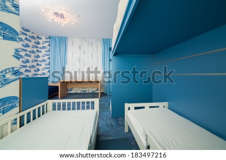 Beautiful modern children bedroom with wallpapers with cars.