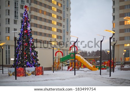 RUSSIA, MOSCOW - JAN 14, 2014: A modern house with playground and Christmas tree in the yard in Housing Complex Elk Island