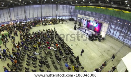 RUSSIA, MSCOW - JAN 25, 2014: Aerial view to people sitting in chairs in front of stage at largest European festival of modern technology, science and art Geek Picnic.