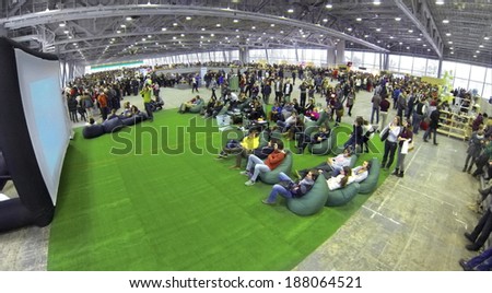 MOSCOW, RUSSIA - JAN 25, 2014: Aerial view to people sitting on soft chairs near the screen at Geek Picnic. Is largest European festival of modern technology, science and art.