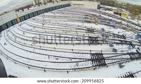 Depot with many railway lines covered with snow at autumn day, aerial view