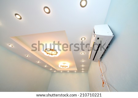 Modern ceiling with a lot of lights and air conditioner in the new apartment