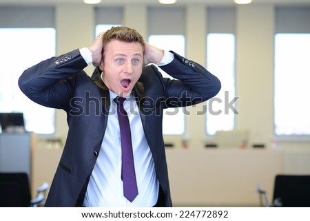 Very frightened businessman clutched his head in office