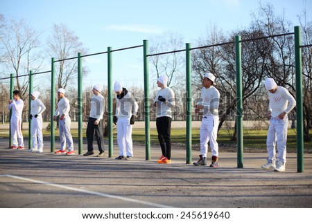 Eight young people near the long horizontal bar at the playground