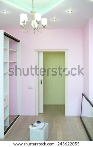 Installation of white sliding wardrobe and mirror door in room with pink walls