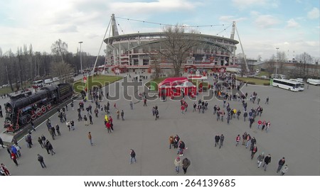 MOSCOW, RUSSIA - MAR 30, 2014: Lot of people walk away from Locomotive sports stadium after football match at spring day. Aerial view.