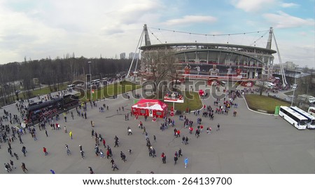 MOSCOW, RUSSIA - MAR 30, 2014: Lot of people walk away from Locomotive sports stadium after soccer match at spring day. Aerial view