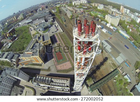 Tall tubes of boiler house near school and railway station at sunny day, aerial view