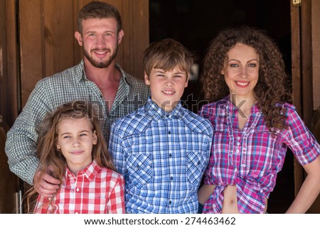 father mother daughter and son closeup family of four portrait focus on children